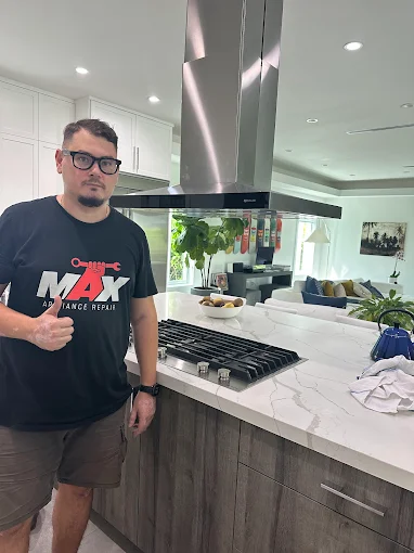 Technician fixing appliances in Miami kitchen