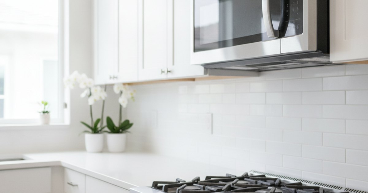 Stainless steel over-the-range microwave above a cooktop in a kitchen